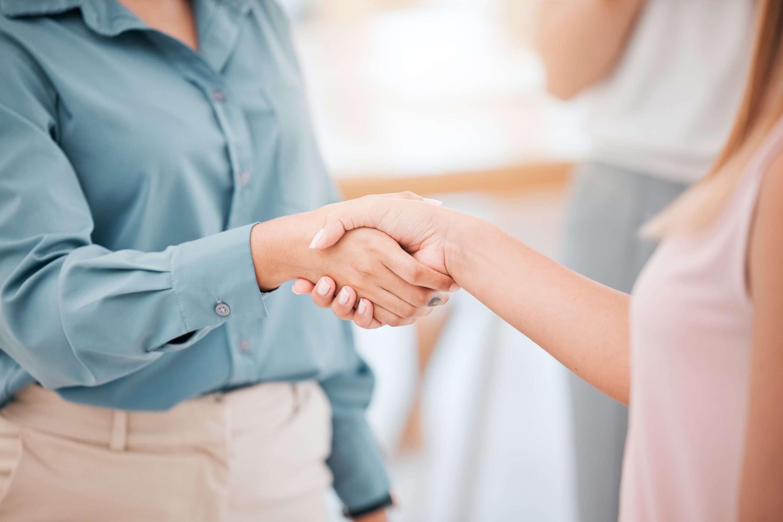 Two women shaking hands